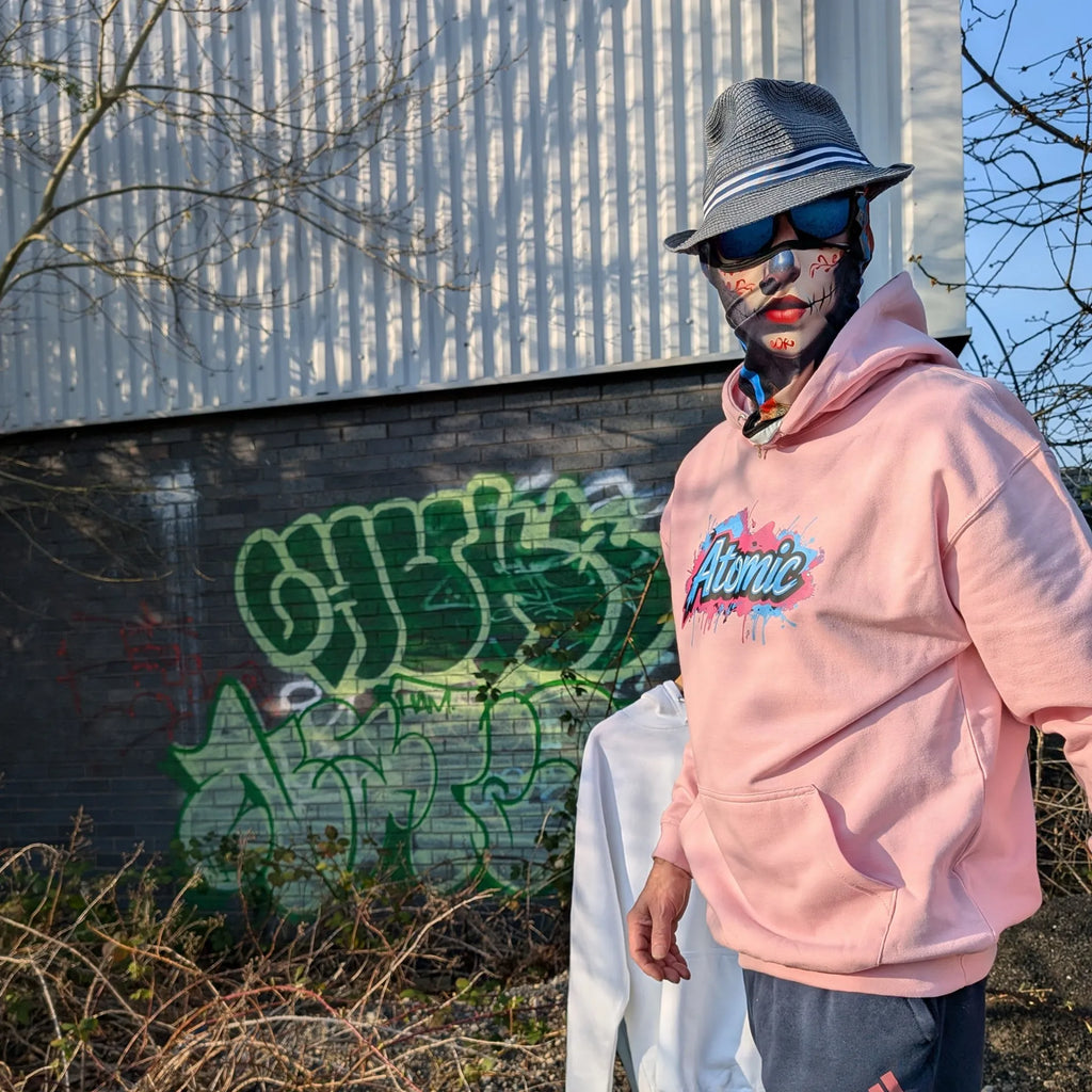 The Sun Walker wearing a Al Hazzati Atomic New Wave baby pink hoodie in Manchester graffiti location